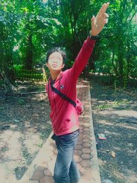 Full length of woman standing by plants