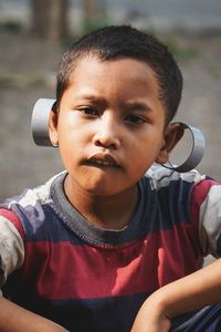 Portrait of boy with metal on ears