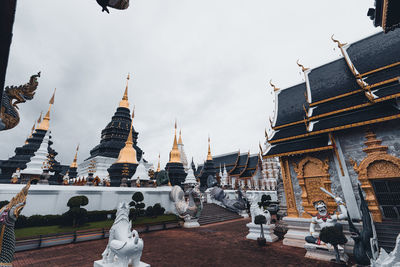 Panoramic view of temple and buildings against sky