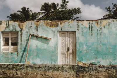 Exterior of old abandoned house during sunny day