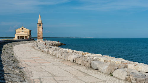 Scenic view of sea by building against sky
