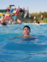 Portrait of boy swimming in pool