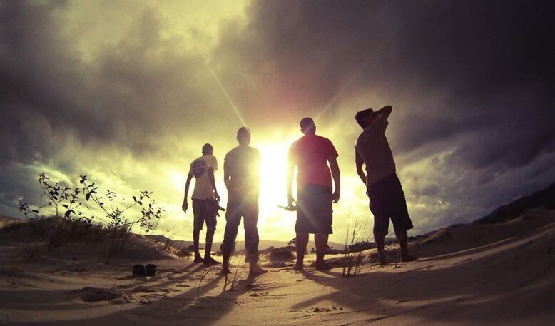 SILHOUETTE OF MEN ON BEACH