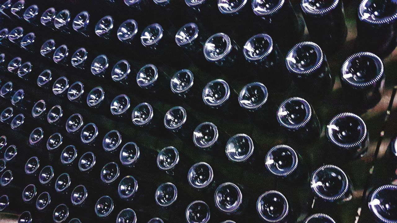 FULL FRAME SHOT OF WINE BOTTLES IN GLASS