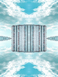 Reflection of building on water against sky