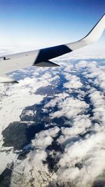 Aerial view of snow covered landscape against sky