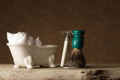 Close-up of shaving equipment on table