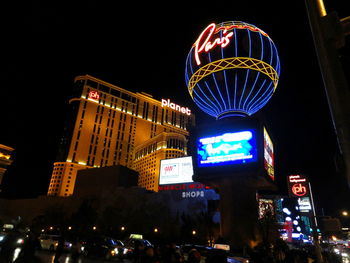 Low angle view of illuminated ferris wheel at night