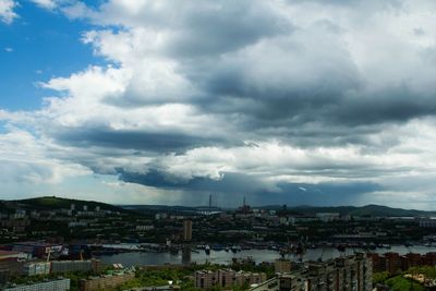 High angle view of houses against cloudy sky