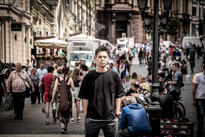 Portrait of people standing on street in city