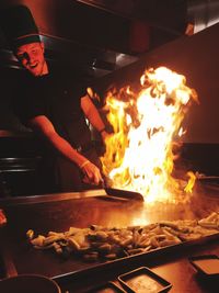 Chef preparing food at kitchen in hotel