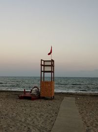 Lifeguard hut on beach against clear sky