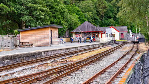 Railroad station platform by trees in city