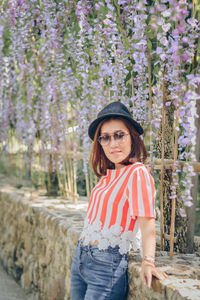 Portrait of beautifyl asian woman wear black hat sunglass and red and white t shirt. 
