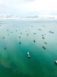 High angle view of sailboats in sea against sky