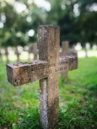 Close-up of cross against stone wall