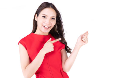 Portrait of smiling young woman against white background