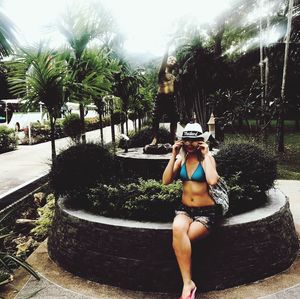 Full length of young woman standing in swimming pool