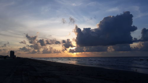 Scenic view of beach against sky during sunset