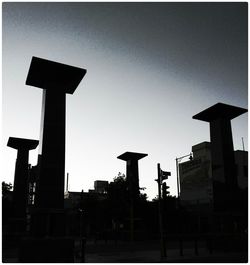 Silhouette of buildings against sky at sunset