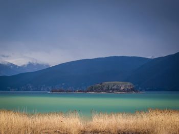 Scenic view of lake and mountains against sky