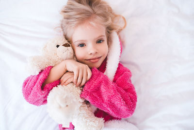 Portrait of cute baby girl sleeping on bed