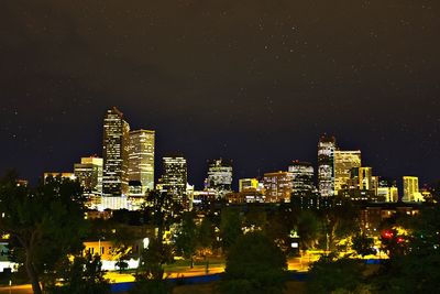Low angle view of city lit up at night