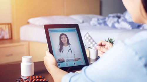 Midsection of woman using mobile phone