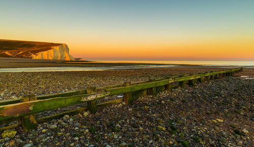 Scenic view of sea against clear sky during sunset