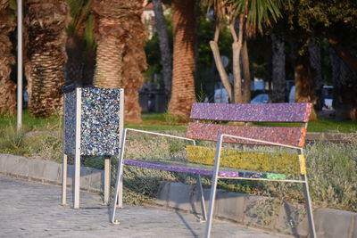 Empty chairs and table in park