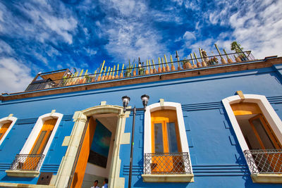 Low angle view of building against cloudy sky