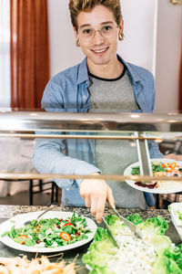 Portrait of smiling man holding food