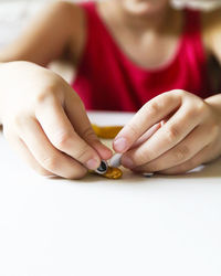 Close-up of hands decorating clay at table