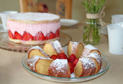 Close-up of pastries and strawberries in plate on table