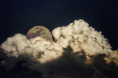 Low angle view of moon against sky at night