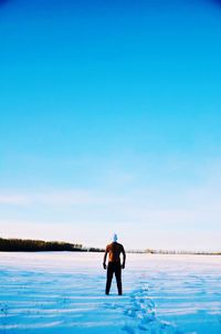 Full length of man standing in sea against sky