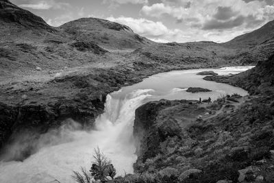 Scenic view of waterfall against sky