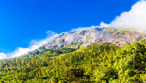 Scenic view of mountains against blue sky