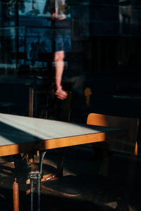 Blurred motion of man standing by table at cafe