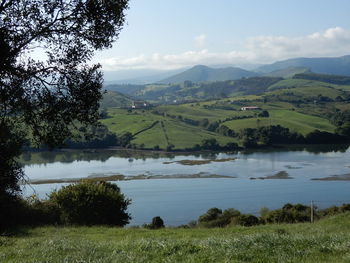 Scenic view of landscape and lake against sky