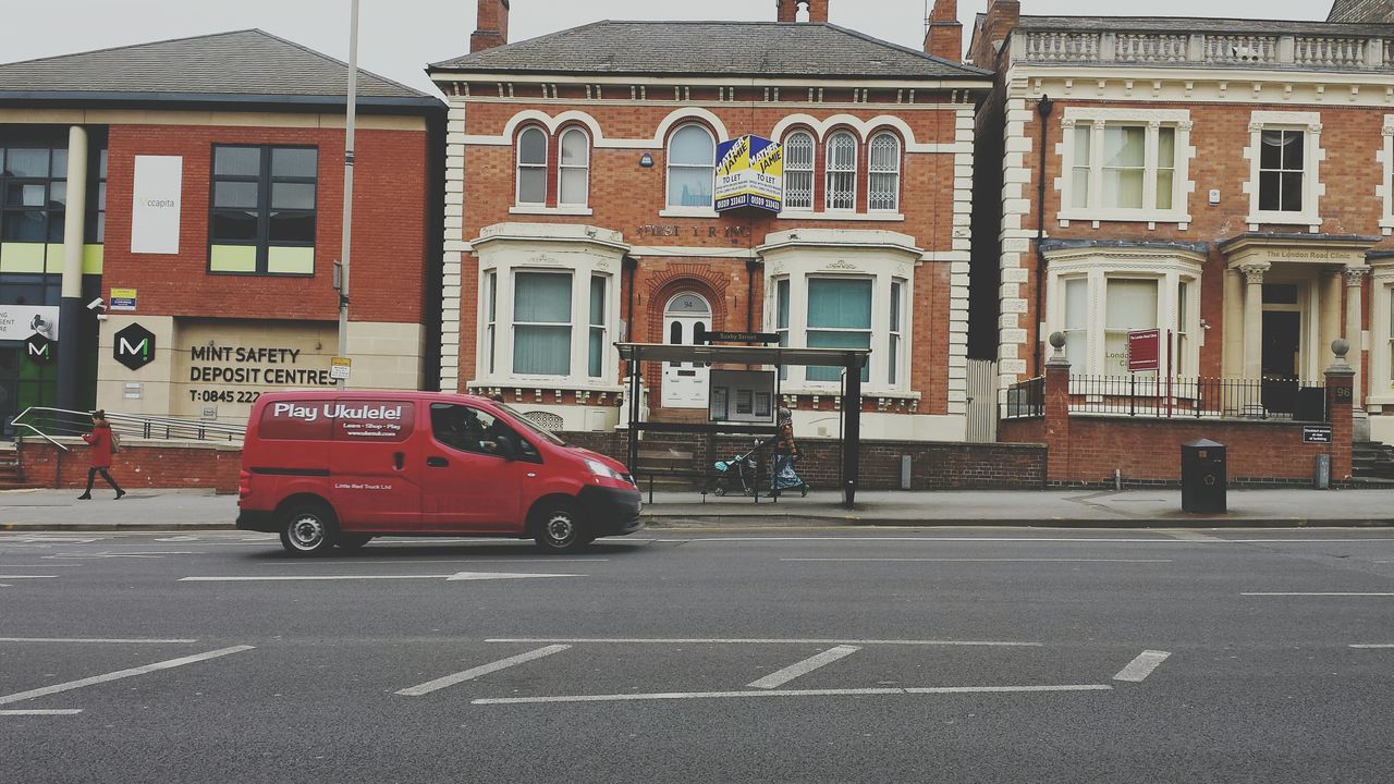 building exterior, architecture, built structure, street, transportation, road, car, land vehicle, city, road marking, mode of transport, city street, building, city life, road sign, incidental people, day, the way forward, outdoors, residential structure