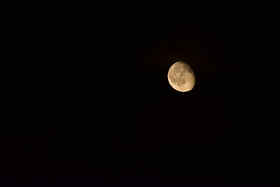 Low angle view of moon against clear sky at night