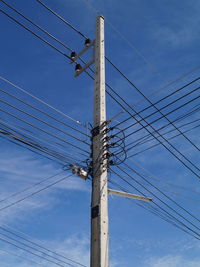 Low angle view of telephone line against sky