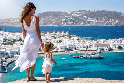 Woman standing by sea