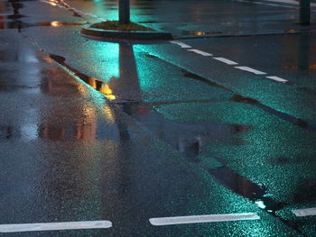 Close-up of wet illuminated road during rainy season