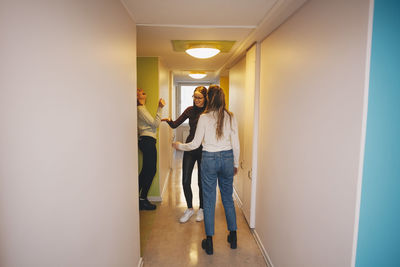 Woman standing in corridor of building