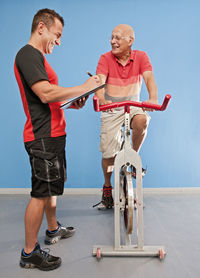 Personal trainer with senior client at gym in the uk