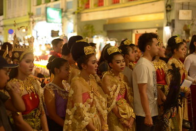 Group of people looking at market in city