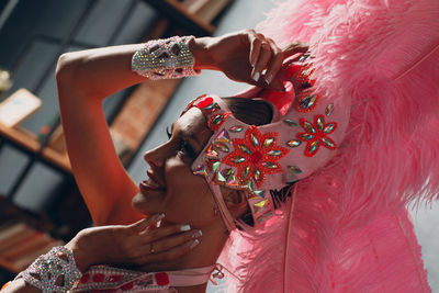 Midsection of woman holding red umbrella