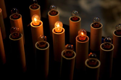 Close-up of illuminated candles on table